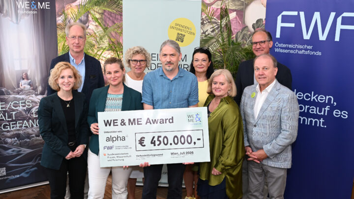 Nine people are standing together at Ströck Feierabend on Burggasse, smiling and posing with a large check for over 450,000 € for the “WE&ME Award” to benefit ME/CFS, surrounded by WE & ME and FWF banners. From left to right: Minister of Science Eva-Maria Holzleitner, Oswald Wagner (MedUni Vienna), Kathryn Hoffmann (MedUni Vienna), Sabine Seidler (alpha+ Foundation), Matthias Wielscher (MedUni Vienna), Ursula Jakubek (FWF), Gabriele and Gerhard Ströck (WE&ME Foundation), Christoph Binder (FWF).